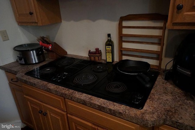 kitchen with brown cabinetry and black electric cooktop