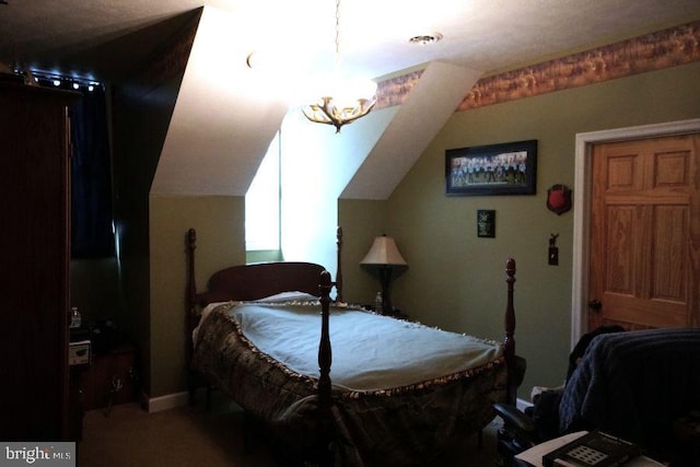 bedroom with lofted ceiling and a notable chandelier