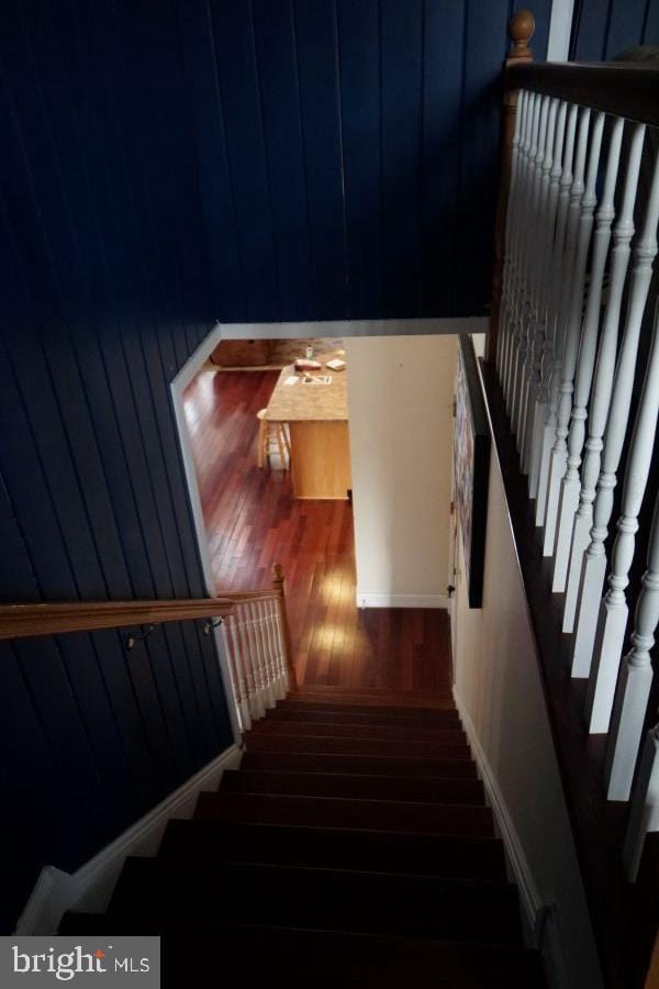 staircase with wood finished floors