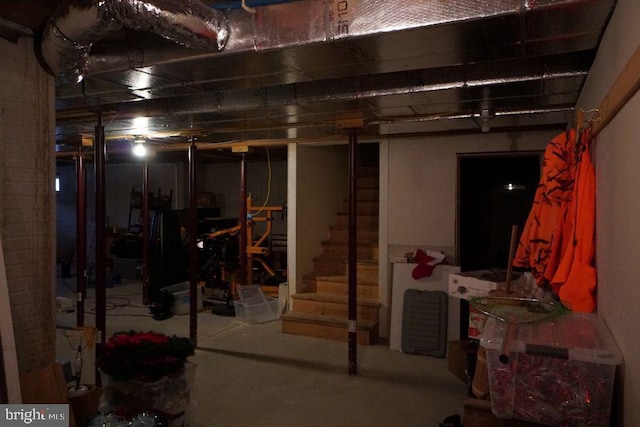 unfinished basement featuring stairway