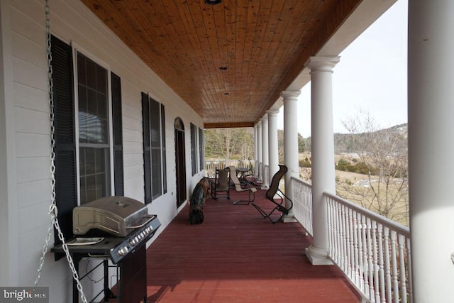 wooden terrace featuring grilling area