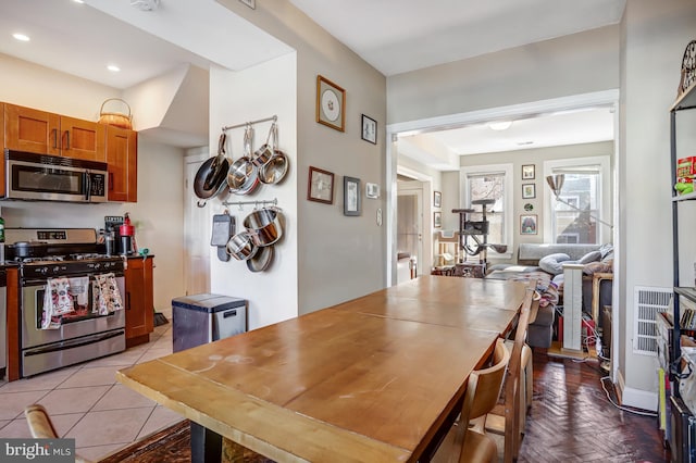 dining space featuring light tile patterned flooring and recessed lighting