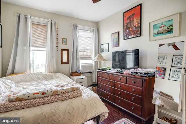 bedroom with dark wood-type flooring