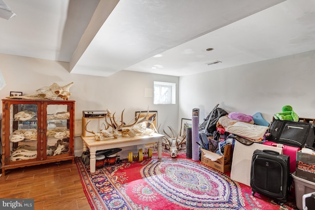 bedroom featuring visible vents and wood finish floors