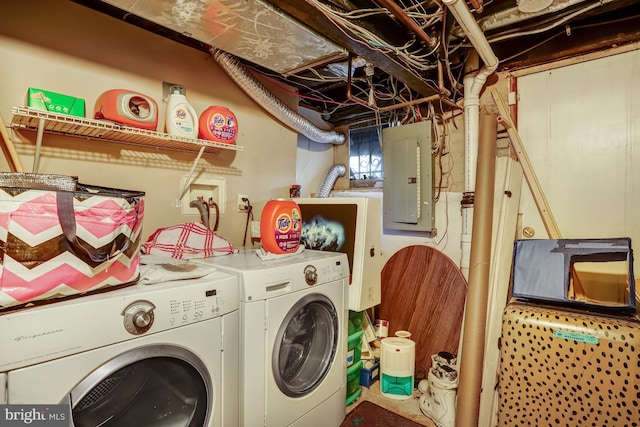 clothes washing area featuring laundry area, electric panel, and washer and clothes dryer