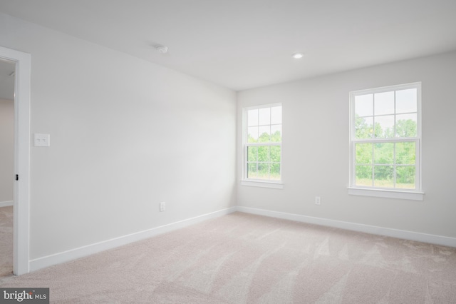 unfurnished room with light carpet, baseboards, and recessed lighting