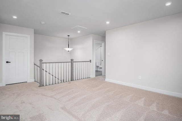 empty room featuring recessed lighting, baseboards, visible vents, and light colored carpet