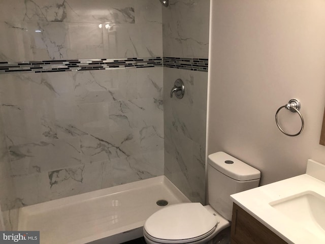 full bath featuring toilet, a shower stall, and vanity