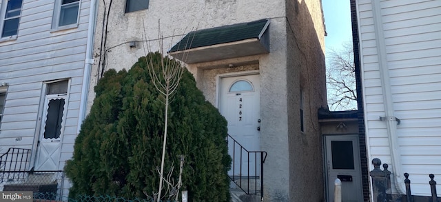 view of exterior entry with stucco siding