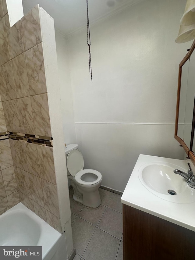 bathroom featuring vanity, tile patterned flooring, ornamental molding, and toilet
