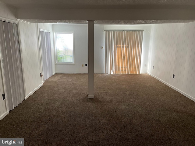 carpeted spare room featuring baseboards