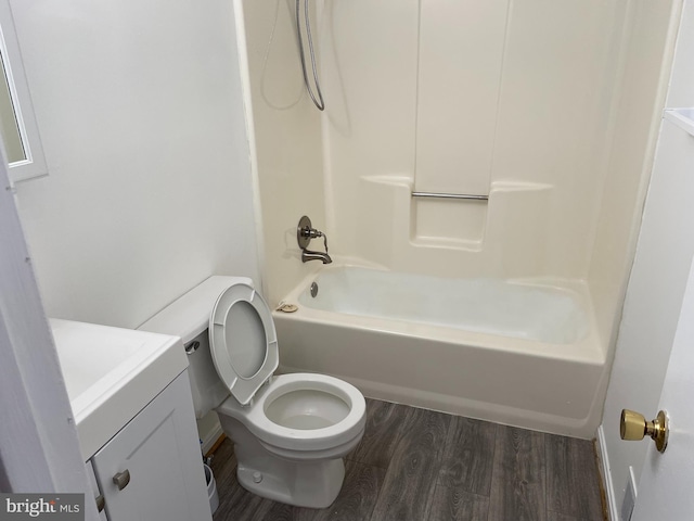 bathroom featuring vanity, shower / tub combination, wood finished floors, and toilet