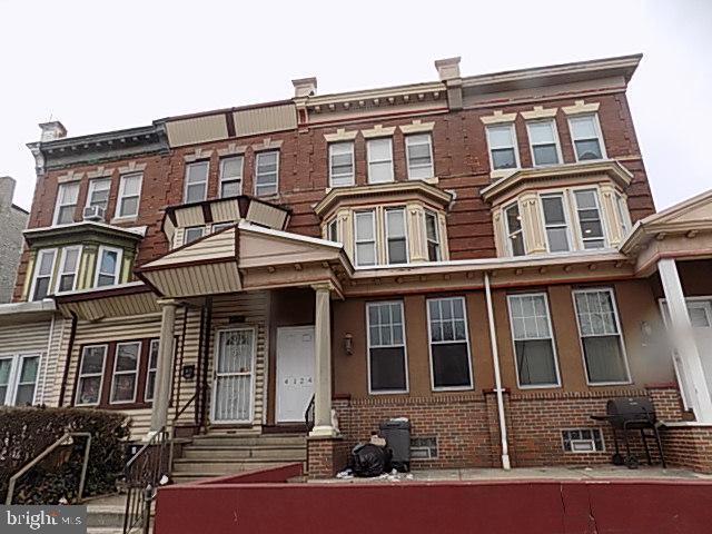 multi unit property with entry steps and brick siding