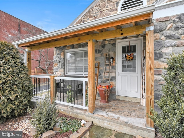 view of exterior entry featuring stone siding