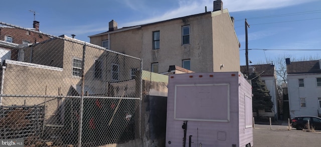 view of home's exterior featuring fence and stucco siding