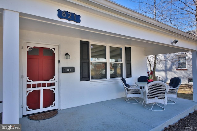 property entrance with stucco siding