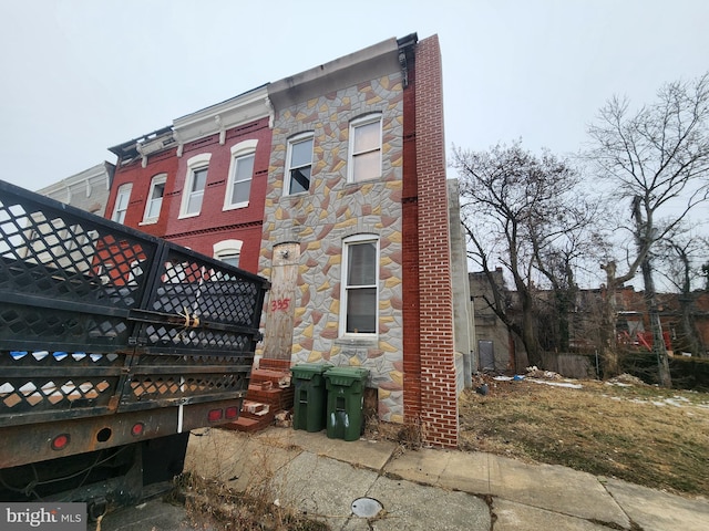 view of home's exterior featuring stone siding and brick siding