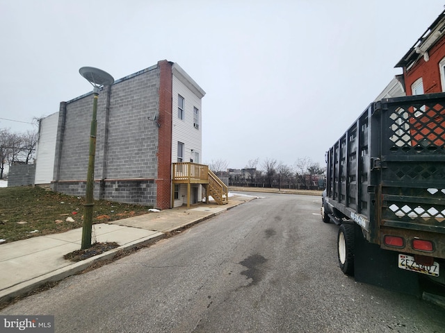 view of street featuring sidewalks, stairs, and curbs