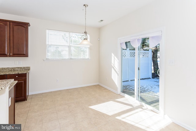 unfurnished dining area featuring visible vents and baseboards