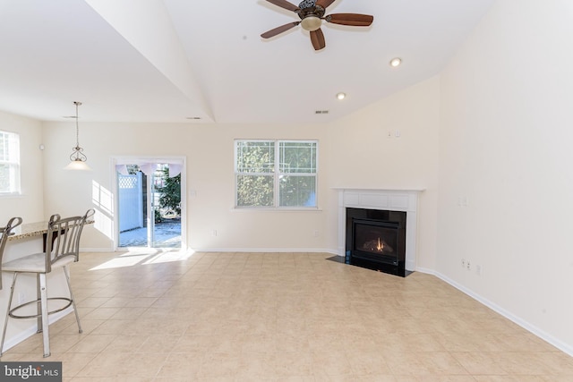 unfurnished living room featuring baseboards, ceiling fan, a fireplace with flush hearth, vaulted ceiling, and recessed lighting