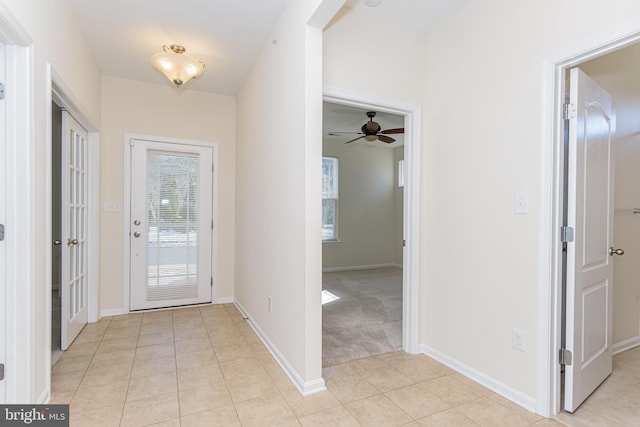 foyer with light tile patterned floors and baseboards