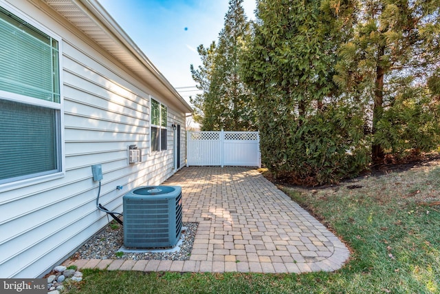 view of patio with fence and central air condition unit