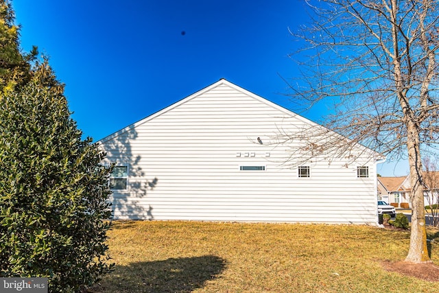 view of property exterior featuring a lawn