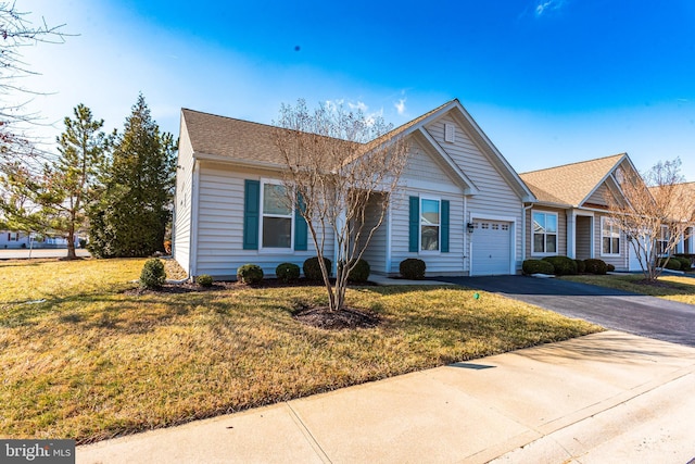 ranch-style house with driveway, a garage, and a front yard