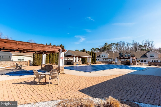 community pool featuring a patio area, a residential view, a pergola, and a gazebo