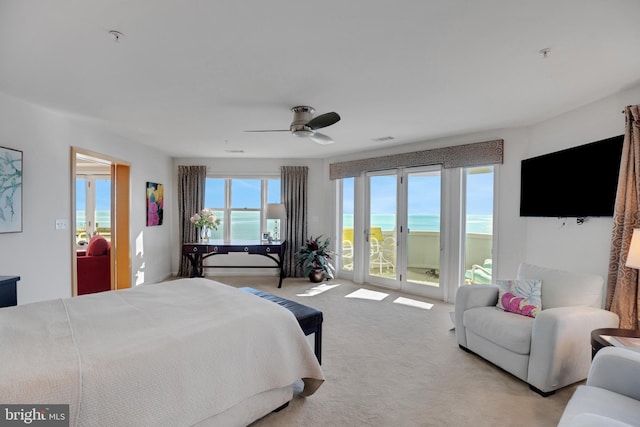 bedroom with a ceiling fan, access to outside, light carpet, and visible vents