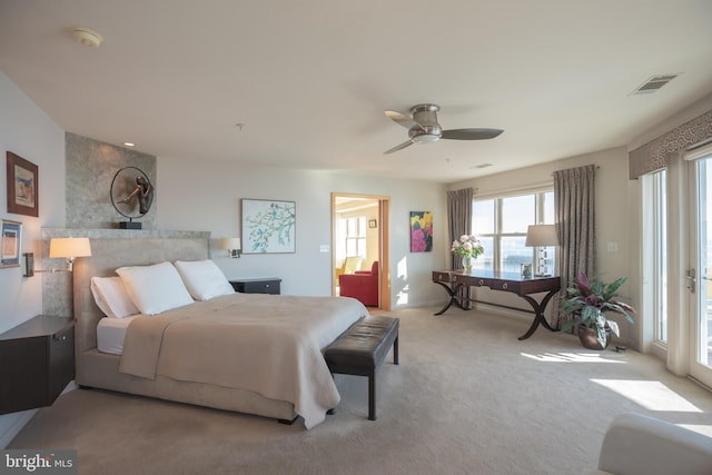 bedroom with ceiling fan, access to outside, carpet, and visible vents