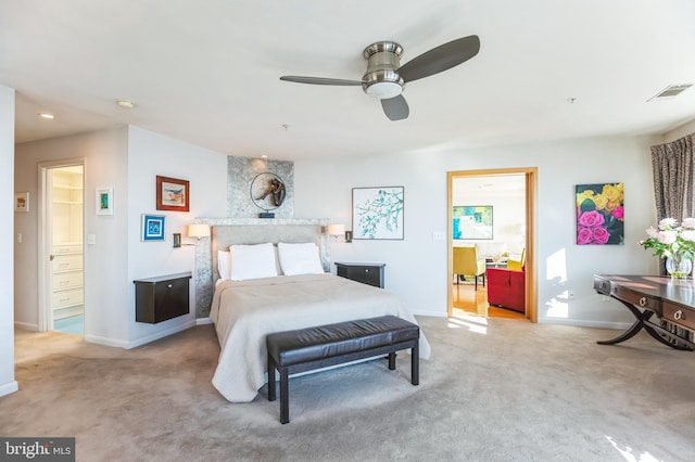 carpeted bedroom featuring baseboards, visible vents, and ceiling fan