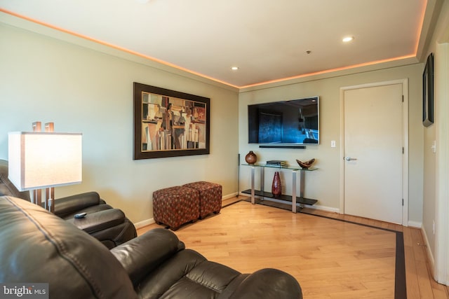 living room with light wood-style floors, baseboards, and recessed lighting