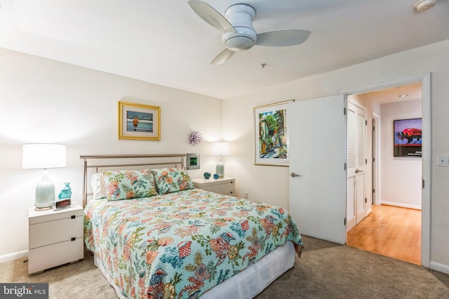 carpeted bedroom with baseboards and a ceiling fan