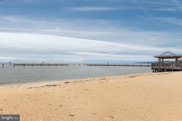 view of water feature with a beach view and a gazebo