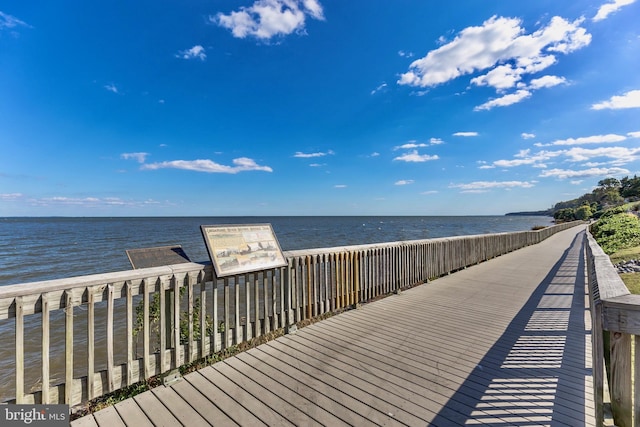 dock area with a beach view and a water view