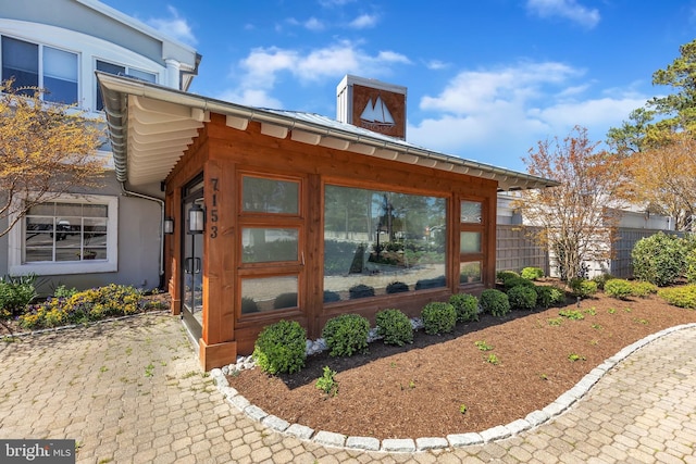 view of home's exterior featuring fence