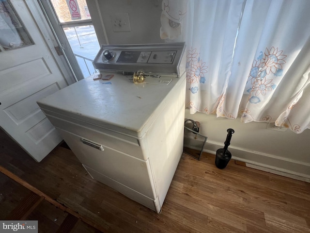 details with washer / clothes dryer and wood finished floors