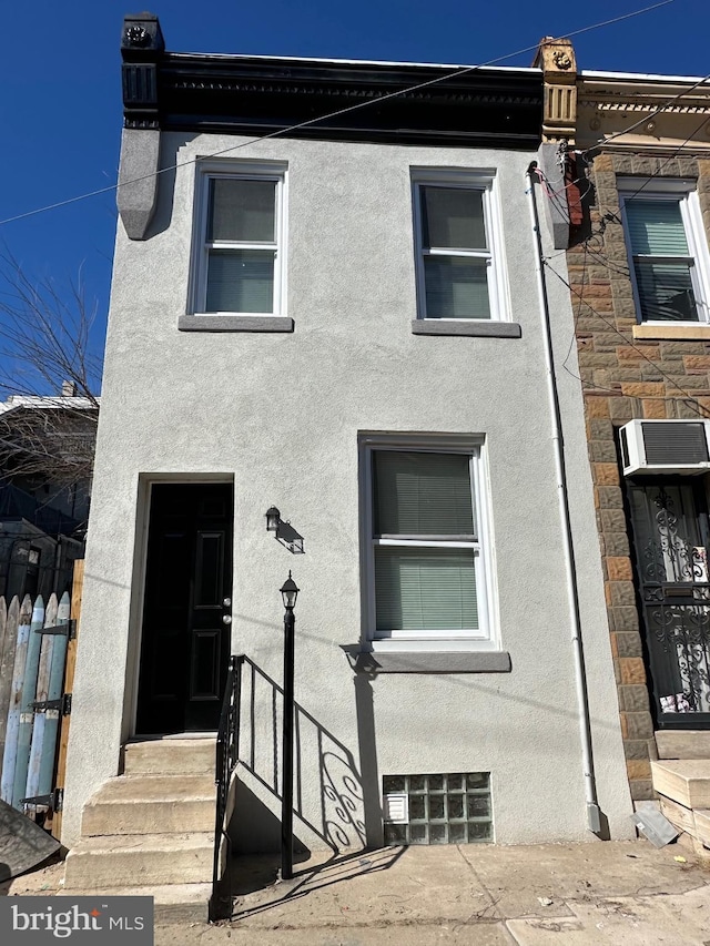 view of property with entry steps and stucco siding