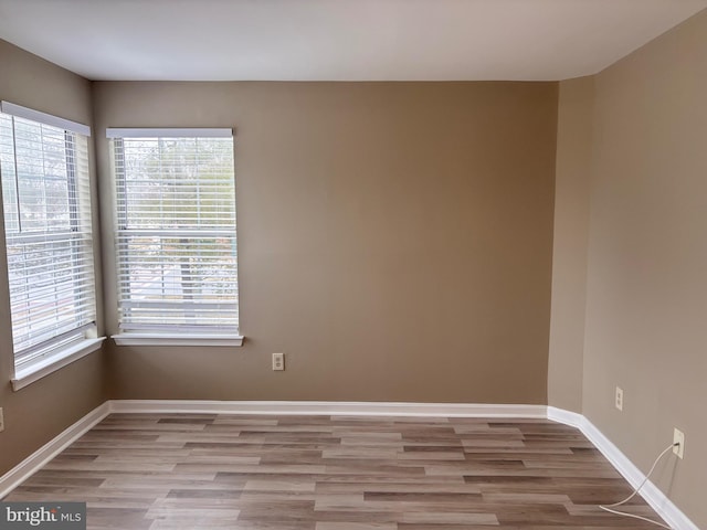 empty room featuring light wood-style floors and baseboards