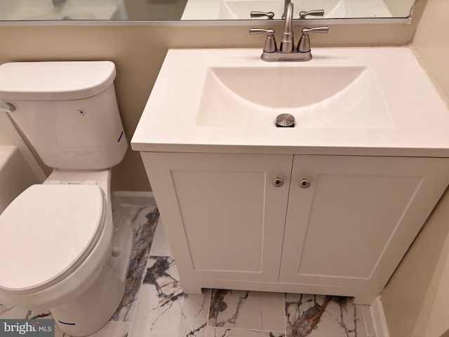 bathroom with marble finish floor, baseboards, vanity, and toilet