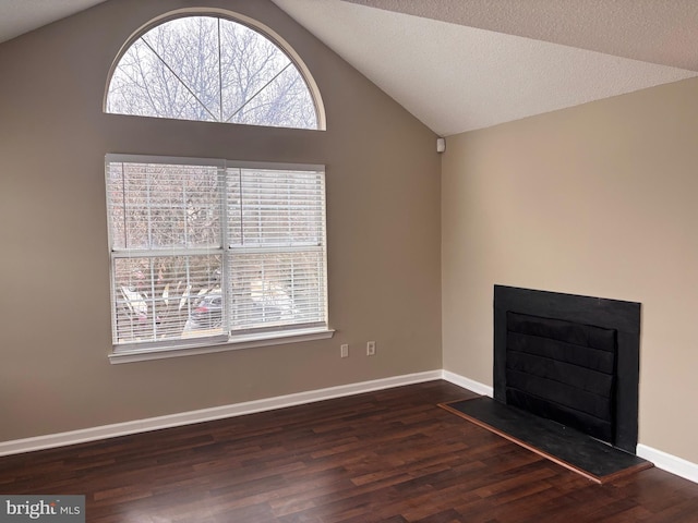 unfurnished living room with dark wood-style floors, a fireplace, lofted ceiling, a textured ceiling, and baseboards