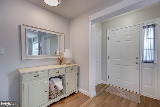 entrance foyer with light wood-style floors and baseboards