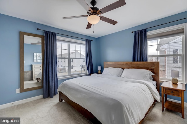 bedroom with ceiling fan, carpet floors, and baseboards