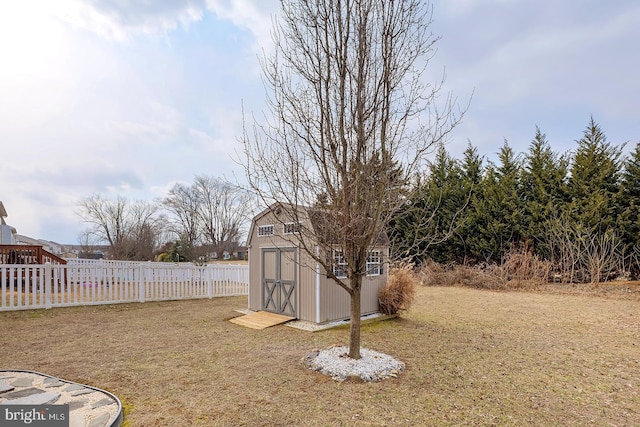 view of yard with an outbuilding, fence, and a storage unit