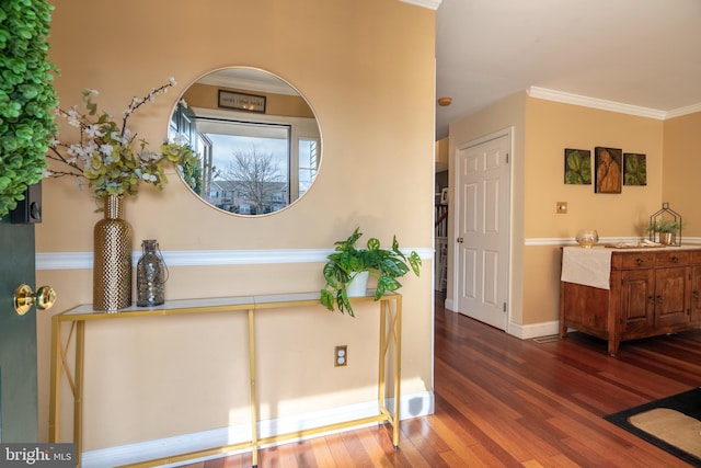 entryway with crown molding, baseboards, and dark wood-style flooring