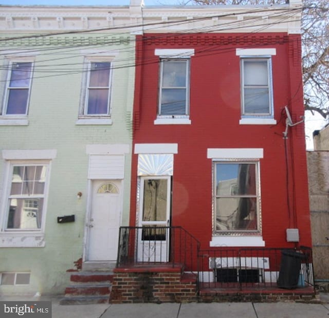 townhome / multi-family property featuring brick siding