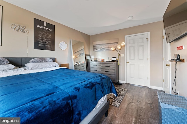 bedroom with baseboards and wood finished floors