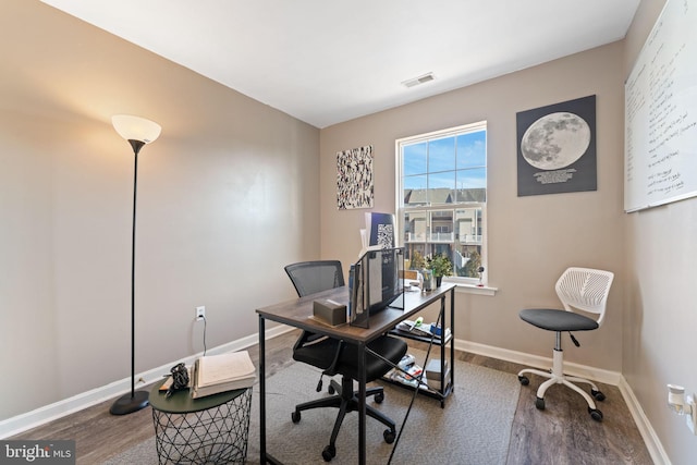 home office featuring visible vents, baseboards, and wood finished floors