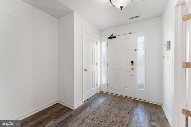 entrance foyer with visible vents, baseboards, and wood finished floors